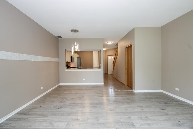 218 Partridge Ct, Algonquin, IL 60102 - unfurnished living room with light wood-style flooring and stairway