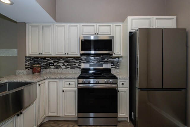 218 Partridge Ct, Algonquin, IL 60102 - kitchen with stainless steel appliances, tasteful backsplash, light stone countertops, and white cabinets