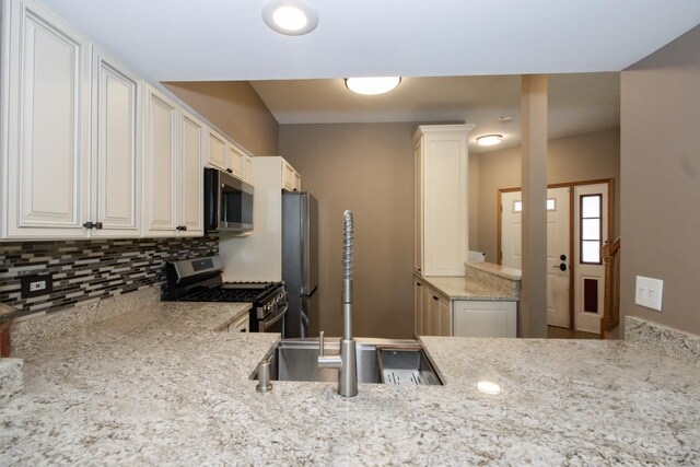 218 Partridge Ct, Algonquin, IL 60102 - kitchen with stainless steel appliances, decorative backsplash, light stone countertops, and white cabinets
