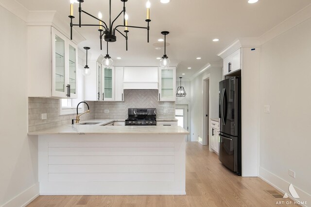 6012 S Narragansett Ave, Chicago, IL 60638 - kitchen with a sink, gas range, fridge with ice dispenser, a peninsula, and tasteful backsplash
