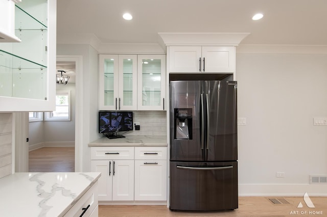 6012 S Narragansett Ave, Chicago, IL 60638 - kitchen with stainless steel fridge with ice dispenser, light stone counters, glass insert cabinets, white cabinets, and recessed lighting