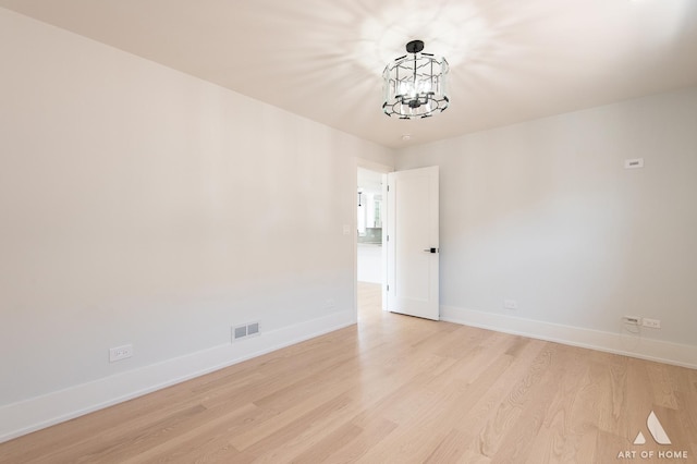 6012 S Narragansett Ave, Chicago, IL 60638 - spare room with a chandelier, light wood finished floors, and baseboards