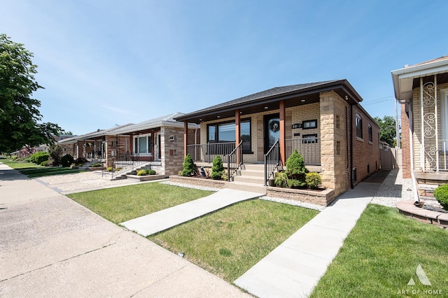 6012 S Narragansett Ave, Chicago, IL 60638 - view of front of home featuring covered porch, brick siding, and a front yard