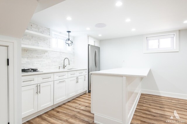 6012 S Narragansett Ave, Chicago, IL 60638 - kitchen with stainless steel appliances, backsplash, a sink, a peninsula, and plenty of natural light