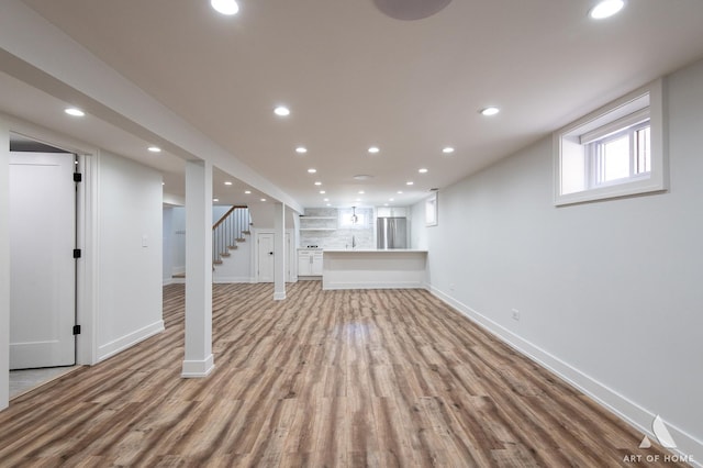 6012 S Narragansett Ave, Chicago, IL 60638 - below grade area with freestanding refrigerator, light wood finished floors, recessed lighting, baseboards, and stairs