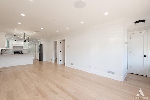 6012 S Narragansett Ave, Chicago, IL 60638 - unfurnished living room with recessed lighting, a sink, light wood-type flooring, baseboards, and a chandelier
