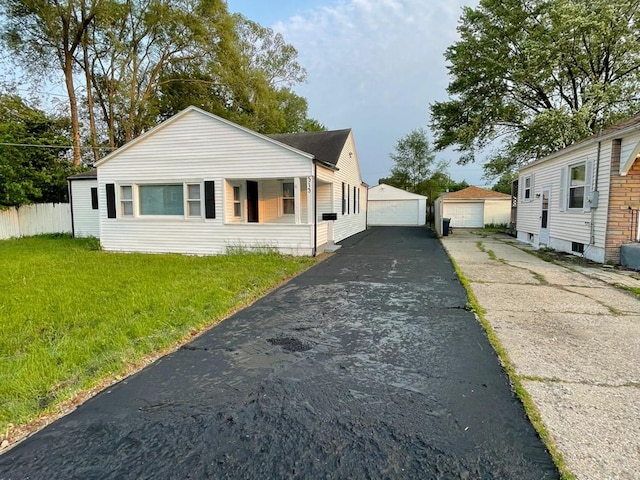 313 Grand Blvd, Loves Park, IL 61111 - view of front of home with a detached garage, a front yard, and an outbuilding