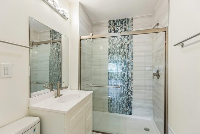 313 Grand Blvd, Loves Park, IL 61111 - full bathroom featuring toilet, a shower stall, and vanity