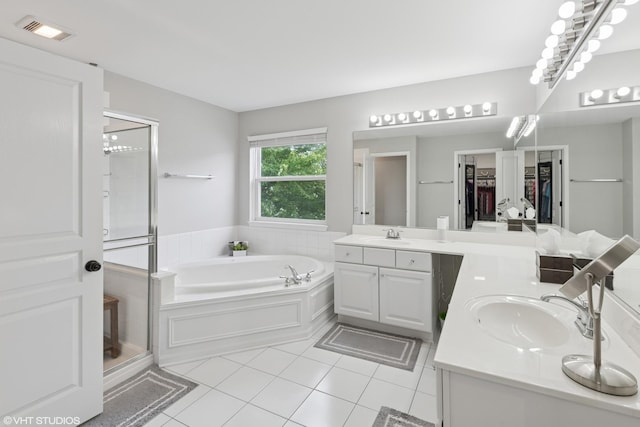 2758 Palm Springs Ln, Aurora, IL 60502 - bathroom featuring a stall shower, two vanities, a garden tub, tile patterned flooring, and a walk in closet