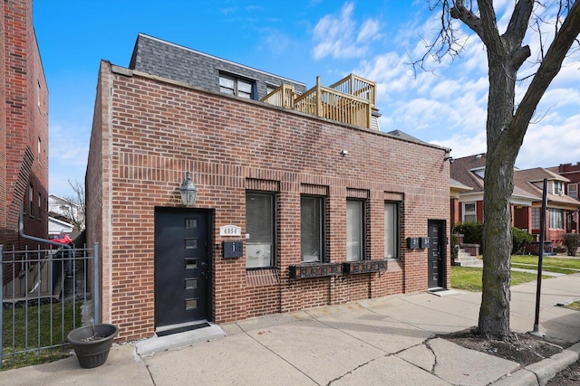4854 W Addison St, Chicago, IL 60641 - view of front of home with brick siding, mansard roof, and a shingled roof