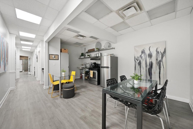4854 W Addison St, Chicago, IL 60641 - dining room with a drop ceiling, wood finished floors, and baseboards