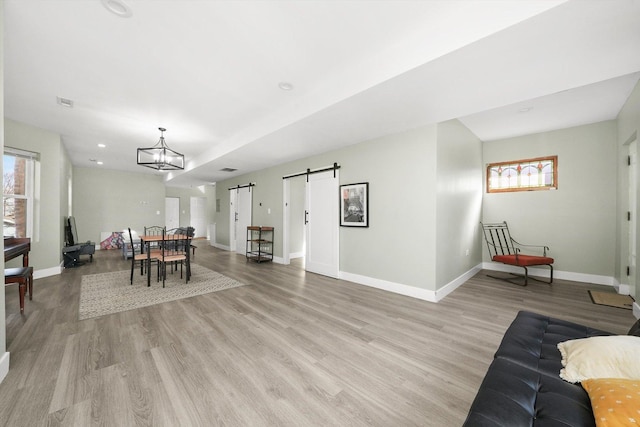 4854 W Addison St, Chicago, IL 60641 - dining room featuring healthy amount of natural light, a barn door, light wood-style floors, baseboards, and recessed lighting