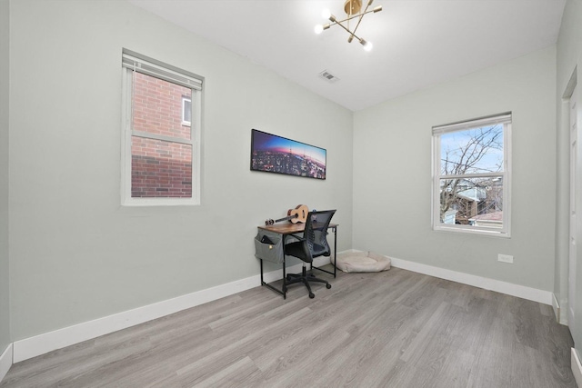 4854 W Addison St, Chicago, IL 60641 - office with light wood-style floors, a chandelier, and baseboards