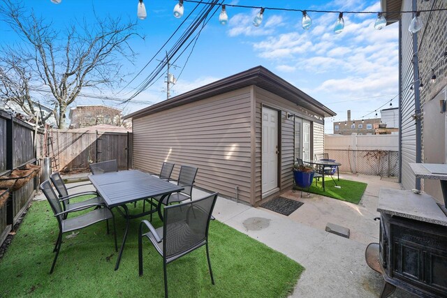 4854 W Addison St, Chicago, IL 60641 - view of patio with outdoor dining space and an outbuilding