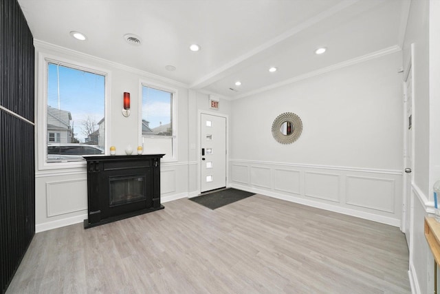 4854 W Addison St, Chicago, IL 60641 - entrance foyer featuring ornamental molding, a decorative wall, light wood-type flooring, a wainscoted wall, and recessed lighting
