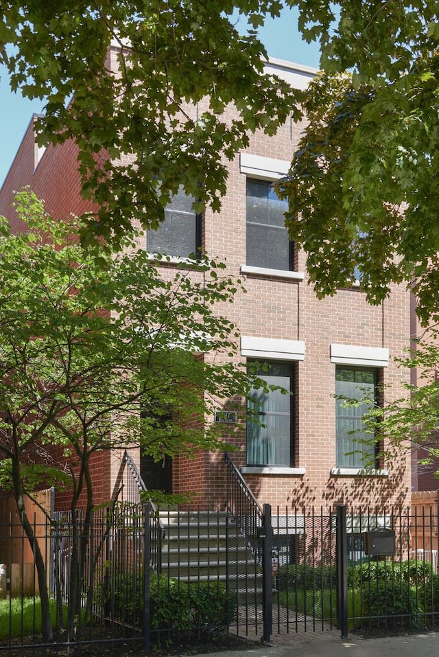 1617 N Bell Ave, Chicago, IL 60647 - view of front of property with a fenced front yard and brick siding