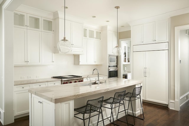 1617 N Bell Ave, Chicago, IL 60647 - kitchen featuring built in appliances, dark wood finished floors, glass insert cabinets, an island with sink, and white cabinets