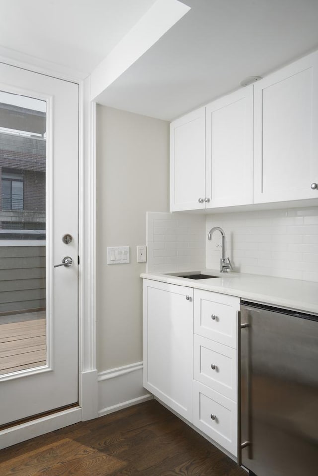 1617 N Bell Ave, Chicago, IL 60647 - indoor wet bar with dark wood finished floors, backsplash, and fridge