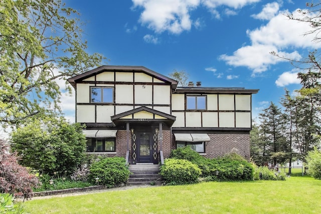 10117 Potter Rd, Des Plaines, IL 60016 - tudor home with brick siding, a front lawn, and stucco siding