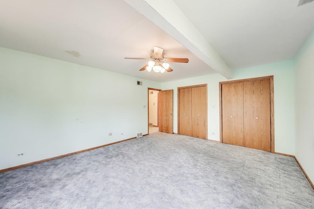10117 Potter Rd, Des Plaines, IL 60016 - unfurnished bedroom featuring carpet, multiple closets, baseboards, and beam ceiling