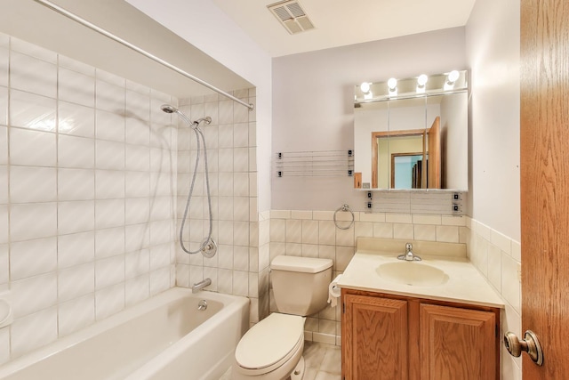 10117 Potter Rd, Des Plaines, IL 60016 - full bathroom featuring bathtub / shower combination, toilet, vanity, and tile walls