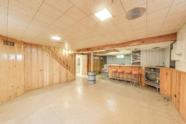 10117 Potter Rd, Des Plaines, IL 60016 - below grade area featuring wood walls, a dry bar, tile patterned floors, and stairs