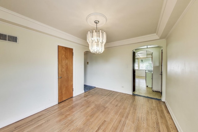 10117 Potter Rd, Des Plaines, IL 60016 - spare room with arched walkways, light wood finished floors, a chandelier, crown molding, and baseboards