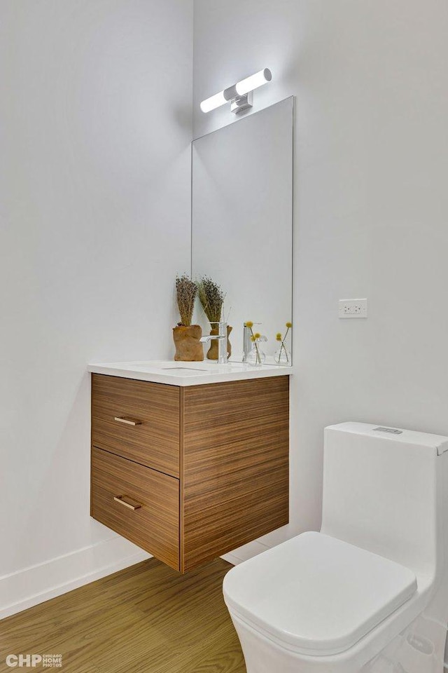 1920 S Shelby Ct, Chicago, IL 60608 - half bathroom with toilet, vanity, wood finished floors, and baseboards