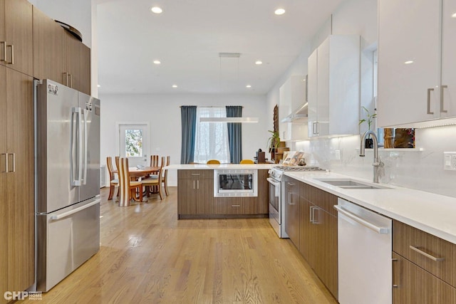 1920 S Shelby Ct, Chicago, IL 60608 - kitchen featuring stainless steel appliances, a sink, modern cabinets, a peninsula, and light countertops