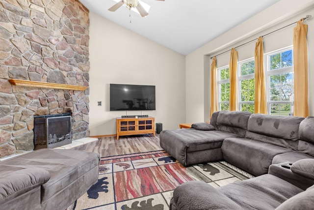 110 SW Benedict Dr, Poplar Grove, IL 61065 - living room with a ceiling fan, wood finished floors, a stone fireplace, and high vaulted ceiling
