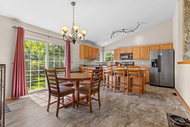 110 SW Benedict Dr, Poplar Grove, IL 61065 - dining space with lofted ceiling, a chandelier, and baseboards