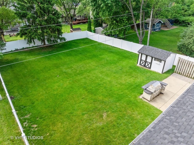 829 Brookside Dr, Bartlett, IL 60103 - fenced backyard with a storage unit and a patio area
