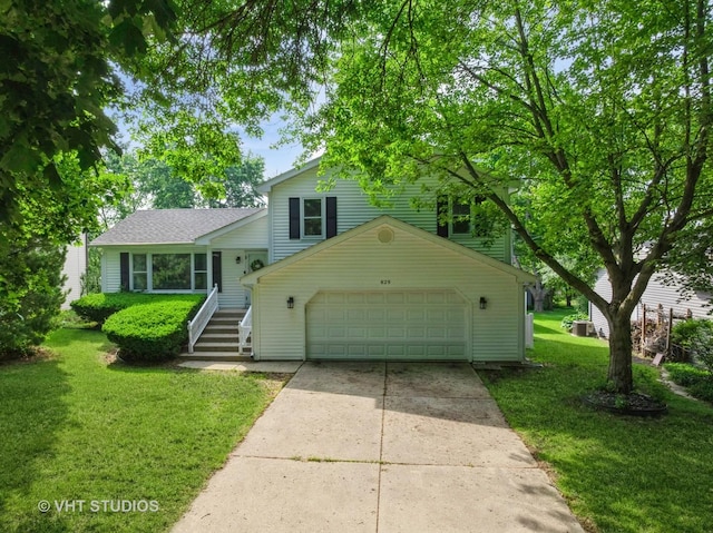 829 Brookside Dr, Bartlett, IL 60103 - split level home with a garage, driveway, and a front lawn