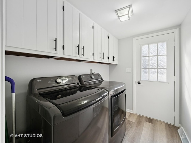 829 Brookside Dr, Bartlett, IL 60103 - laundry area featuring cabinet space, separate washer and dryer, and light wood finished floors