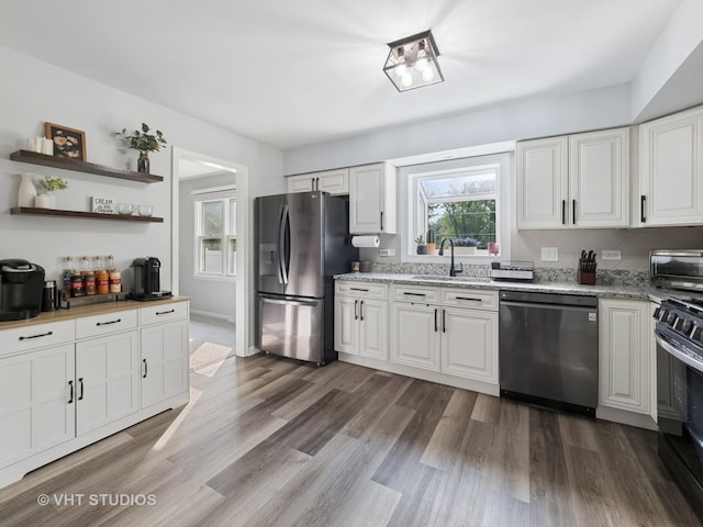 829 Brookside Dr, Bartlett, IL 60103 - kitchen with stainless steel appliances, dark wood-type flooring, white cabinetry, light stone counters, and open shelves