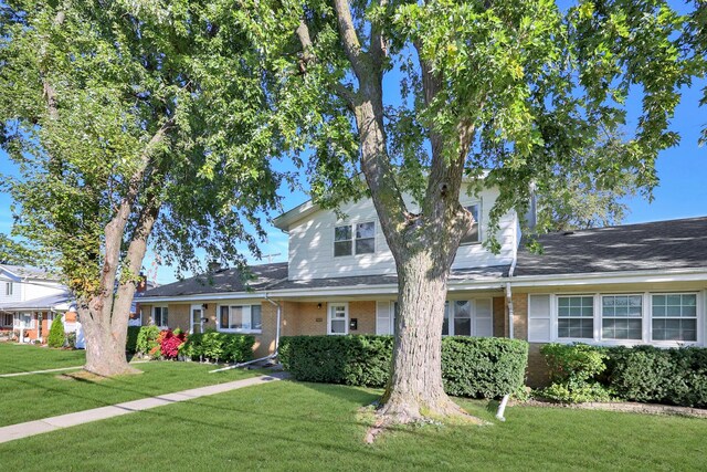 9002 N Clifton Ave, Niles, IL 60714 - traditional-style home featuring a front yard and brick siding