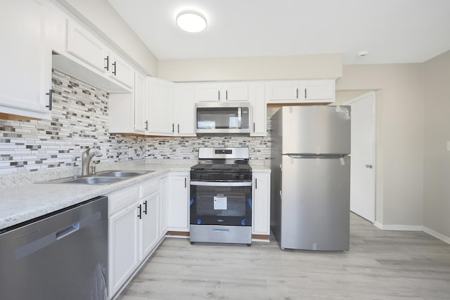 9002 N Clifton Ave, Niles, IL 60714 - kitchen with appliances with stainless steel finishes, a sink, backsplash, and light wood finished floors