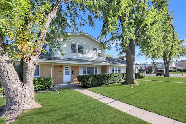 9002 N Clifton Ave, Niles, IL 60714 - traditional-style home featuring a front lawn and brick siding