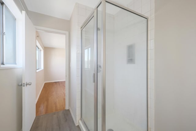9002 N Clifton Ave, Niles, IL 60714 - bathroom featuring a stall shower, wood finished floors, and baseboards