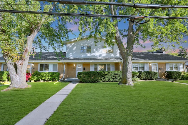 9002 N Clifton Ave, Niles, IL 60714 - traditional home featuring a front yard and brick siding