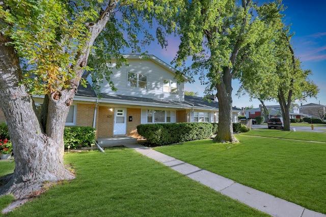 9002 N Clifton Ave, Niles, IL 60714 - traditional-style house featuring a front lawn and brick siding