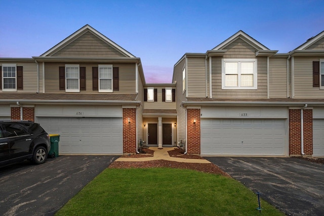 1133 Heron Cir, Joliet, IL 60431 - view of property with asphalt driveway, a garage, and brick siding