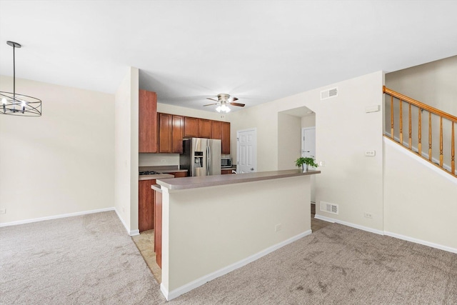 1133 Heron Cir, Joliet, IL 60431 - kitchen featuring stainless steel appliances, light colored carpet, a ceiling fan, and brown cabinetry