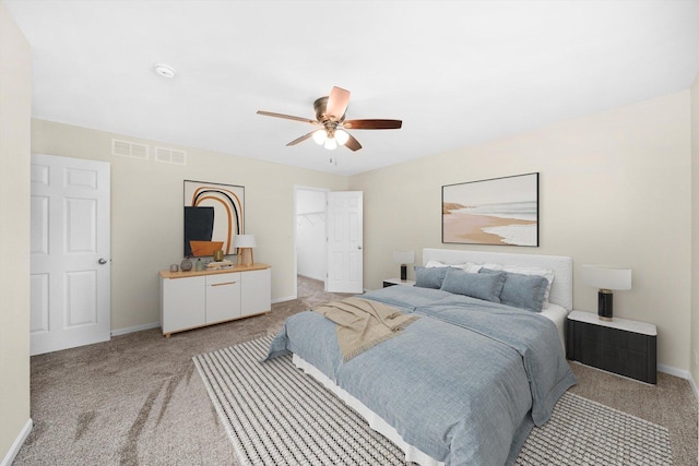 1133 Heron Cir, Joliet, IL 60431 - bedroom with light colored carpet, baseboards, ceiling fan, and a spacious closet
