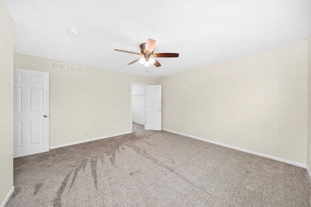 1133 Heron Cir, Joliet, IL 60431 - empty room with a ceiling fan, carpet flooring, and baseboards