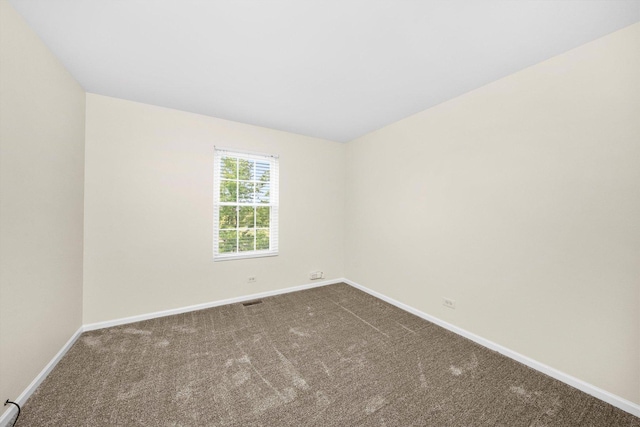 1133 Heron Cir, Joliet, IL 60431 - spare room with baseboards and dark carpet