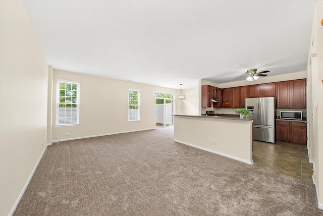 1133 Heron Cir, Joliet, IL 60431 - kitchen featuring appliances with stainless steel finishes, carpet flooring, plenty of natural light, and baseboards