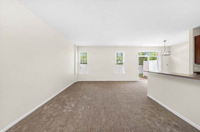 1133 Heron Cir, Joliet, IL 60431 - carpeted spare room with baseboards and a chandelier
