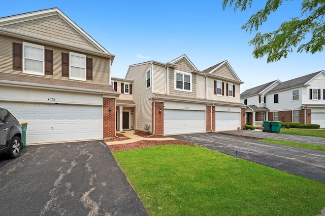 1133 Heron Cir, Joliet, IL 60431 - view of front facade with asphalt driveway, brick siding, and a garage