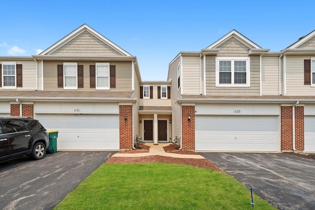 1133 Heron Cir, Joliet, IL 60431 - townhome / multi-family property featuring asphalt driveway, an attached garage, and brick siding
